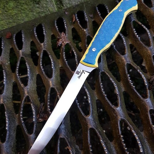 A bespoke custom fishing fillet knife in 14C28N and yellow/blue G10.